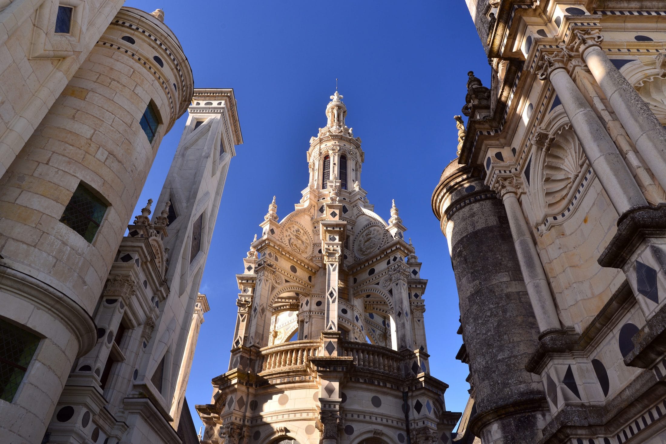 Renaissance architecture of Château de Chambord, France captured on a cloudy day.